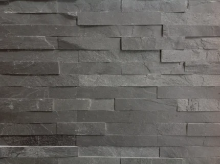 Detail of black slate strip cladding, with a natural surface and dark grey shades.
