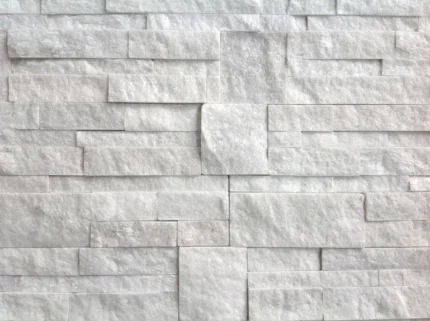 Detail of white Scozzese quartzite cladding, with irregular elements and a natural split surface.