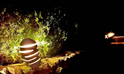 Hollowed natural river stone light feature for lawns and paths, height approximately 30 cm.